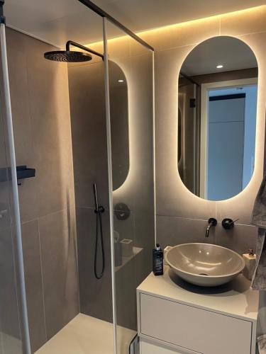 a bathroom with a sink and a mirror at Wellness Oase an der Donau in Wien in Vienna