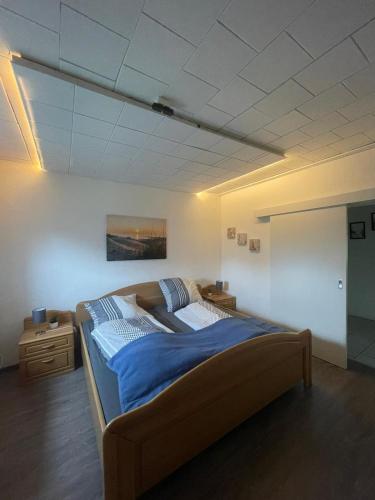 a bedroom with a large bed in a room at Auf dem Land 