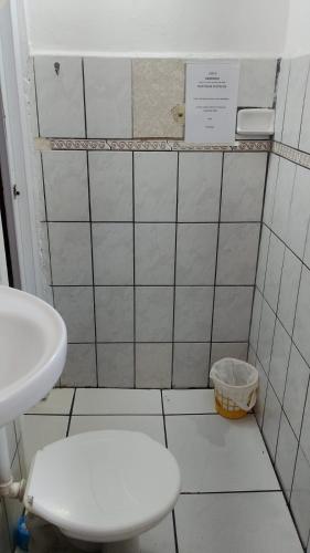 a small bathroom with a toilet and a sink at Hot Iguaçú in Sorocaba