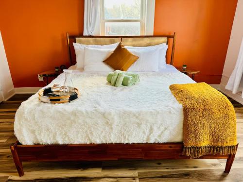 a bedroom with a large bed with orange walls at Jungle House Luxury Homes - Columbus Downtown Short North - Steps to Convention Center & Nationwide Arena - Sleeps up to 8 - Free Parking - Over 5,800 Five Stars in Columbus