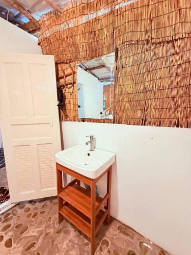 a bathroom with a sink and a mirror at Sweet Jungle Bungalows in Koh Rong Island