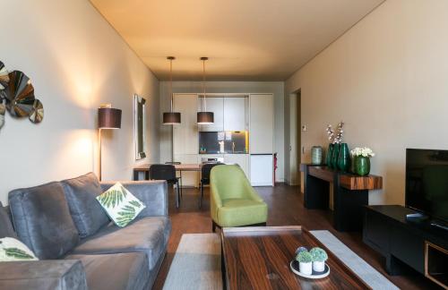 a living room with a couch and a table at Lisbon Five Stars Apartments 8 Building in Lisbon