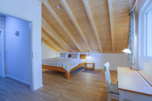 a bedroom with a bed and a wooden ceiling at Am Hafen 21 in Zislow