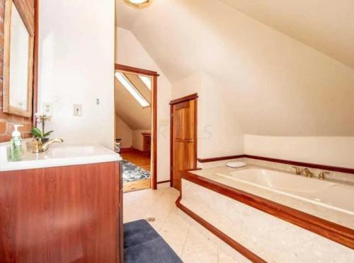 a large bathroom with a tub and a sink at Jungle House Luxury Stays - Columbus Downtown Short North in Columbus