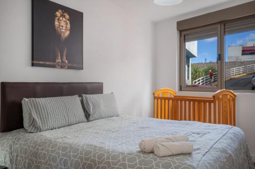 a bedroom with a bed with a large window at Ínsula Home in Tamaraceite