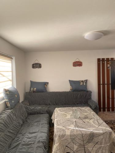 a living room with a couch and a bed at Vikendica- kuća za odmor in Goražde