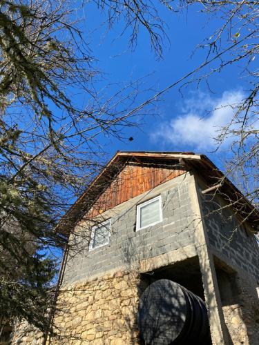 a stone building with a roof on top of it at Vikendica- kuća za odmor in Goražde