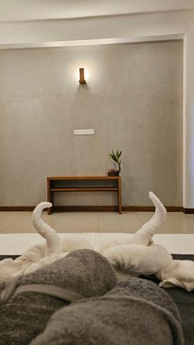 a bedroom with a bed with its arms up at nelli house in Galle