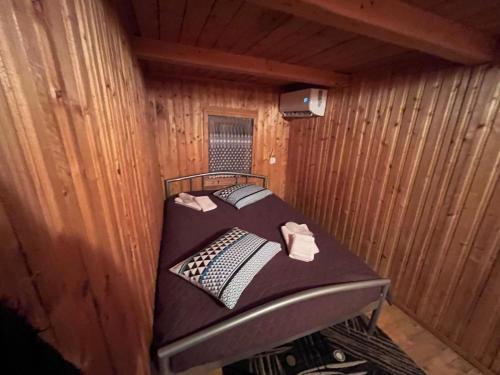 a small room with a bed in a cabin at Cabana Paltini 