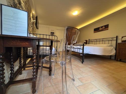 a room with two beds and a table with a screen at Torretta dependance in Assisi