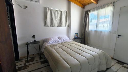 a bedroom with a large bed in a room with a window at Espacio Inn zona Kempes in Córdoba