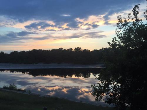 a reflection of the sky in a lake at sunset at B&B Osteria dello sperone in Lonate Pozzolo