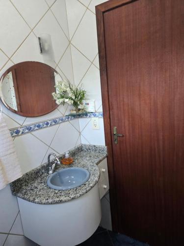 a bathroom with a sink and a mirror at Sítio meu recanto in Paulo Lopes