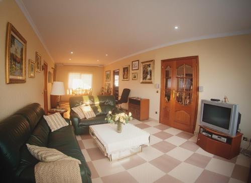 a living room with a couch and a tv at Costa Dorada Villa - Pool BBQ Beach 5min in Calafell