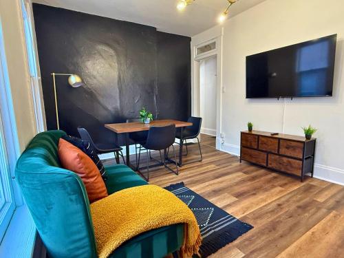 a living room with a couch and a table at Jungle House Columbus Sleep 16 Downtown Ohio Free Parking - Near Convention Center & Nationwide Arena - 4BR Luxury Home - Pet Friendly - Over 5,800 Five Stars in Columbus
