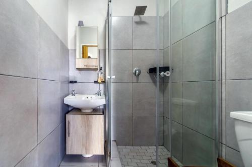 a bathroom with a shower and a sink at The Bridge, Apartment 67 in St Lucia