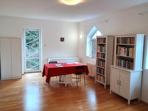 a dining room with a table and a book shelf at Ubytování nad kostelem in Prague