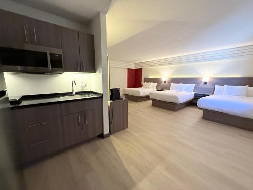 大草原城Westport Inn的一间有两张床和厨房的酒店房间