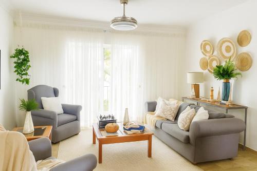 a living room with a couch and a table at Apartamento en Punta Cana, White sands in Punta Cana