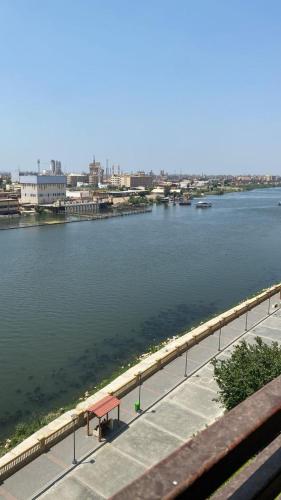 a view of a body of water with a bench at شقة مفروشة سوبر لوكس علي النيل in Mansoura