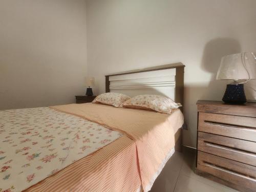 a bedroom with a bed with two pillows and a dresser at Apartamento T1 Mobilado Espargos/Sal in Espargos