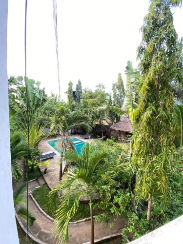 an aerial view of a resort with a pool and trees at Angie's Cozy Studio Diani Beach in Ukunda