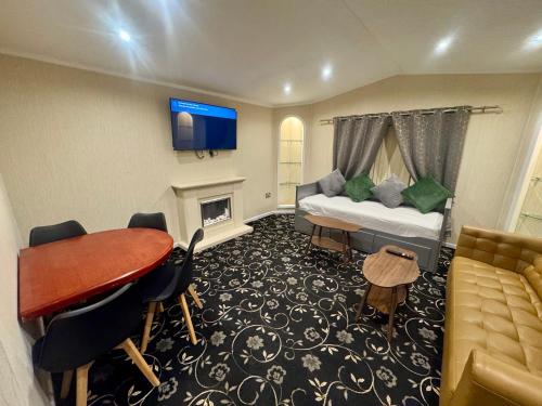 a hotel room with a bed and a table and a couch at Richard guest house in Roydon