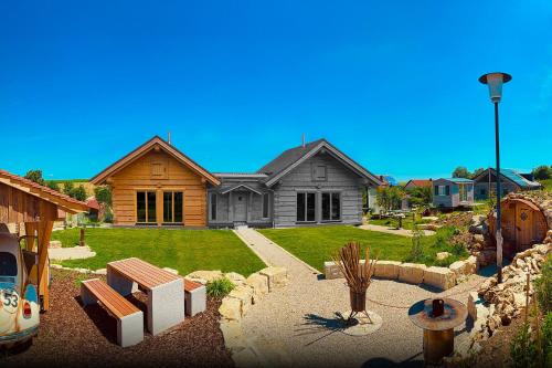 a house with a landscaping in front of it at Chalets Waldeck - Urlaub im Fränkischen Seenland 