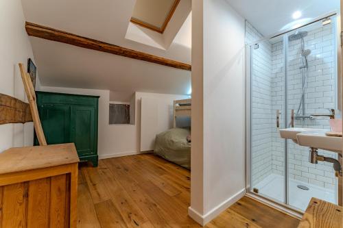 a bathroom with a glass shower and a sink at Chalet des Granges in Saint-Marcel