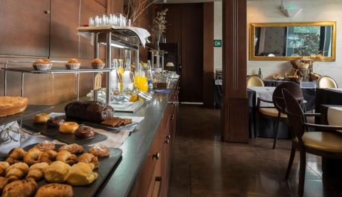a buffet line with bread and pastries on it at Balneario Font Vella- Adults Only in Sant Hilari Sacalm