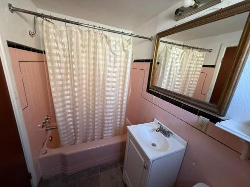 a bathroom with a sink and a toilet and a mirror at Springs Inn by Capital O I 25 in Colorado Springs