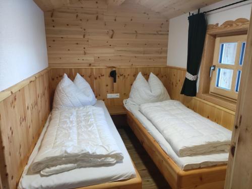 a room with two beds in a cabin at Zeffereralm in Forstau