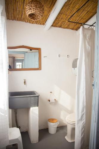 a bathroom with a sink and a toilet at Carmela Suites Cabo Polonio in Cabo Polonio