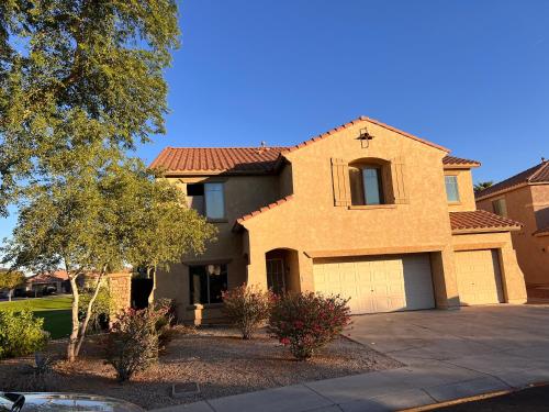 a large brick house with a garage at Westgate Tiny Room 94th in Phoenix