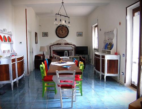 a dining room with a table and colorful chairs at Villa Nini' Exclusive Nature by ElodeaGroup in Pellezzano