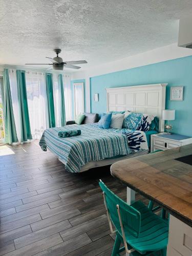 a bedroom with a bed and a table in it at Daytona Inn Beach Resort Step Outside and Put Your Feet in the Sand Beach Vibes in Daytona Beach