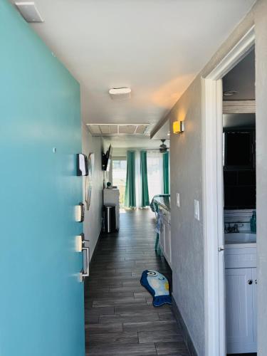 a hallway of a room with a kitchen at Daytona Inn Beach Resort Step Outside and Put Your Feet in the Sand Beach Vibes in Daytona Beach