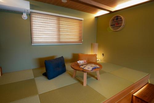 a small room with a table and a blue chair at Tabiudo Stay Miyajima 01-02 - Vacation STAY 20514 in Fukae