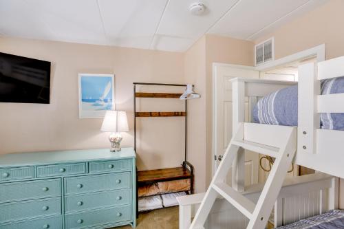 a bedroom with a bunk bed and a dresser at Wildwood Condo with Community Pool Walk to Beach! in Wildwood