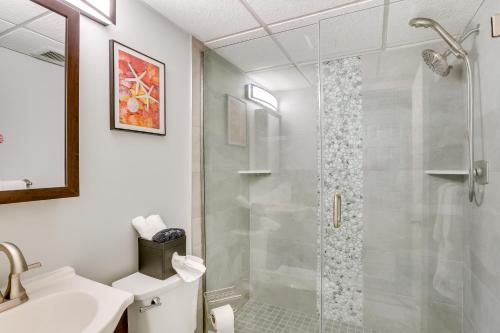 a bathroom with a shower with a glass door at Wildwood Condo with Community Pool Walk to Beach! in Wildwood