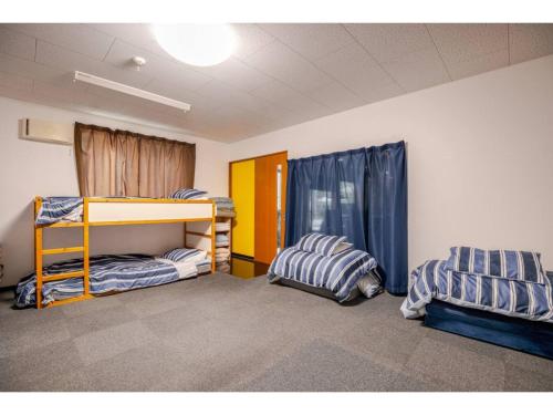 a room with two bunk beds in a classroom at Easy Stay - Vacation STAY 20386 in Harada