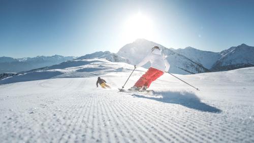 a person is skiing down a snow covered mountain at Stampferhof - Urlaub auf dem Bauernhof - Agriturismo in Racines