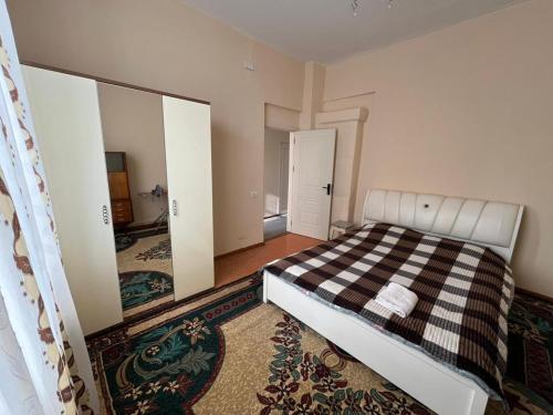 a bedroom with a bed and a large mirror at Aviator Apartment in Bina