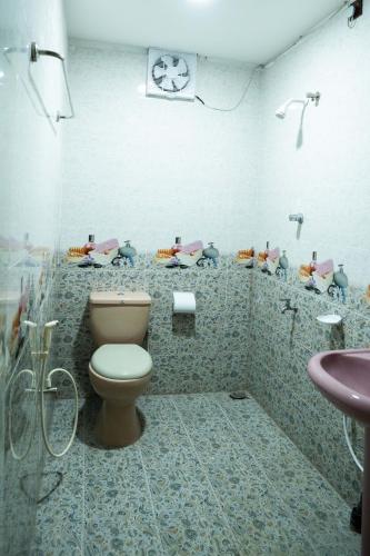 a bathroom with a toilet and a sink at Best Inn in Jaffna