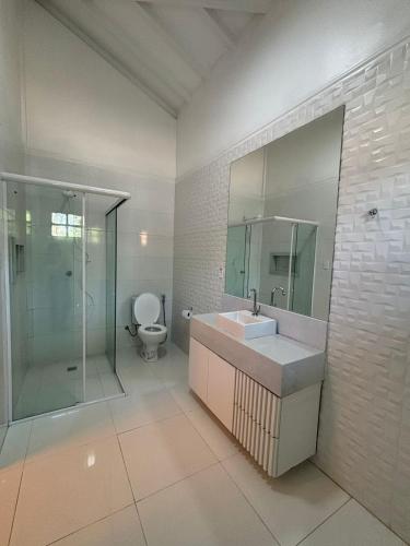 a bathroom with a sink and a shower and a toilet at Ceta Ecotel in Macapá