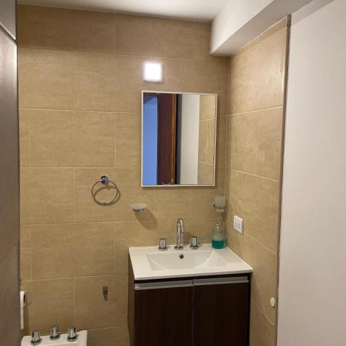 a bathroom with a sink and a mirror at Aire de Mar II - Alojamientos Necochea in Necochea