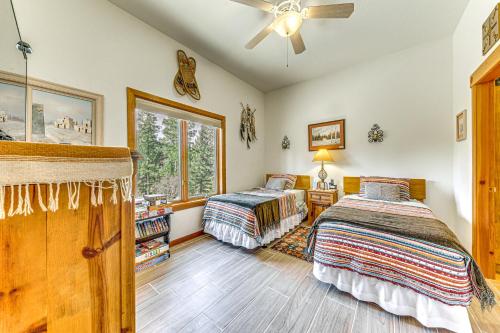 a bedroom with two beds and a ceiling fan at Comfy Aspen Ridge Home about 3 Mi to Ski Lifts in Cloudcroft
