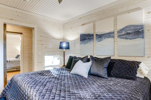 a bedroom with a bed with blue and white pillows at Walk to Marina and Beach Charming Home in Hardin in Aurora