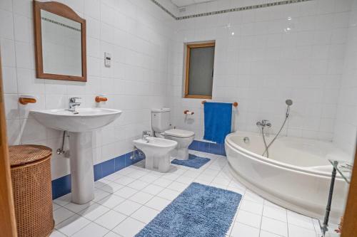 a bathroom with a sink and a tub and a toilet at Spacious 3-Bedroom Apartment with Balconies-Central Sliema in Sliema