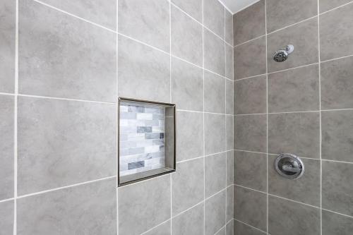 a bathroom with a shower with a window at Pet-Friendly Studio in Historic Dtwn Marshall! in Marshall